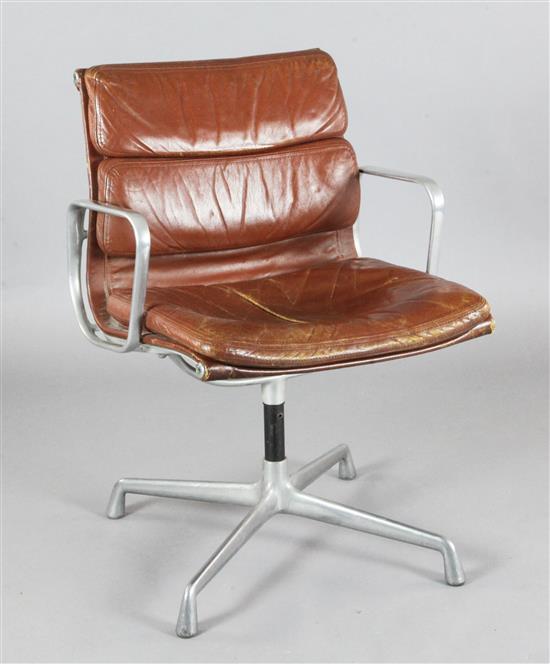 A Ray and Charles Eames EA208 soft pad aluminium and brown leather swivel armchair, W.1ft 1in. H.2ft 9in.
